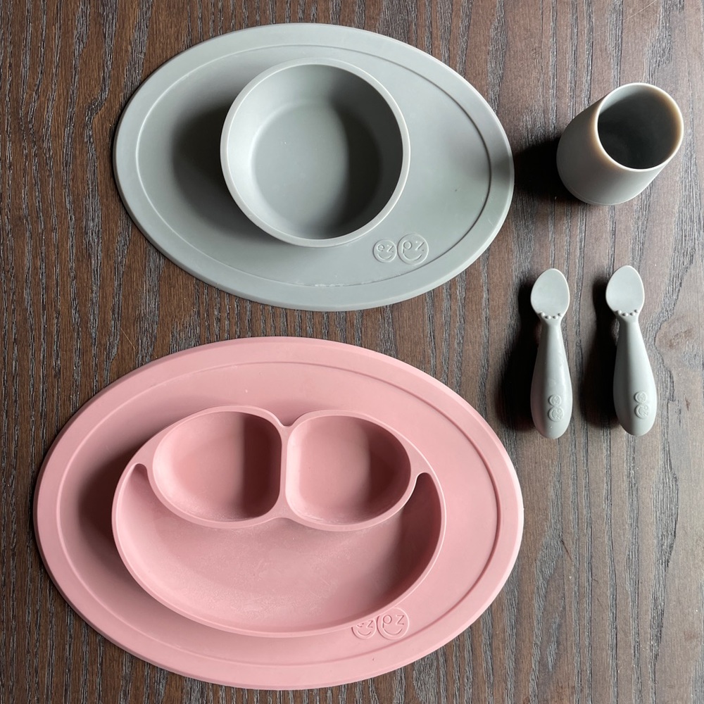 EzPz plate placemat set with two spoons and a drinking cup